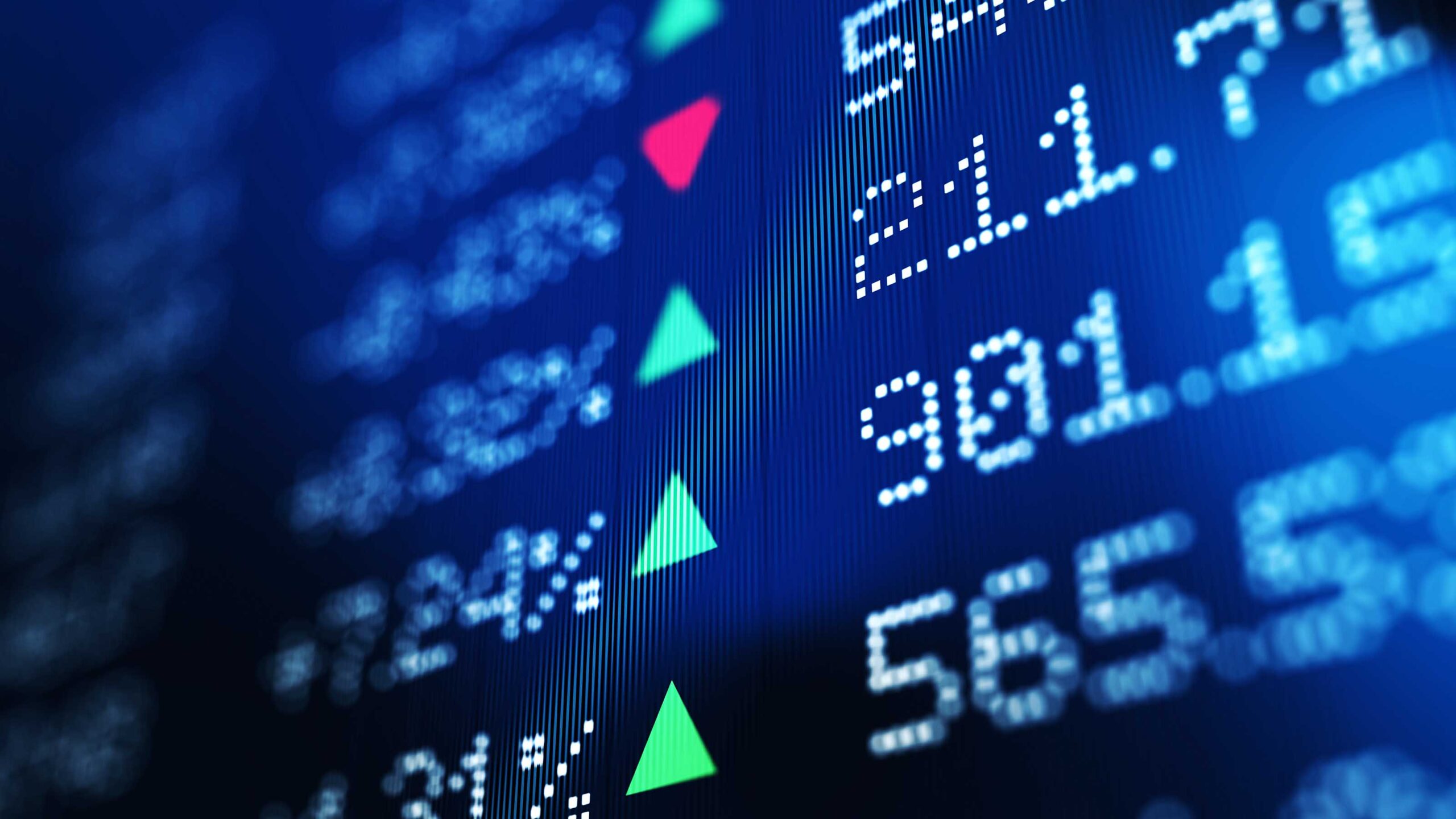 Financial data analysis graph showing stock market trends on a trading board. Horizontal composition with copy space and selective focus.