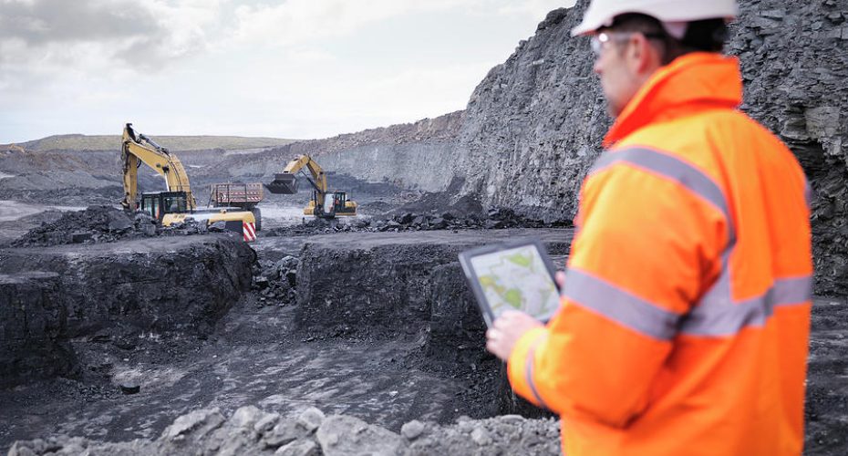 miner-checks-plans-on-digital-tablet-in-monty-rakusen